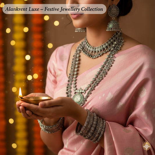 Woman in pink saree wearing traditional silver jewellery, holding diya for Diwali festival
