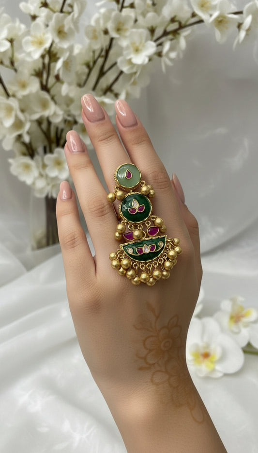 Gold and green jewelry piece held by a gloved hand with 'No 420' label.