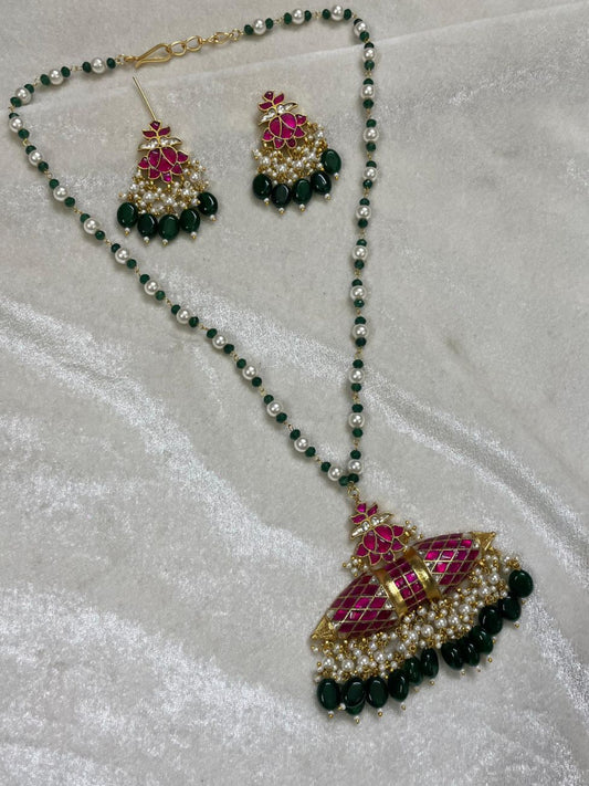 Jewelry set with necklace and earrings on a white fabric background