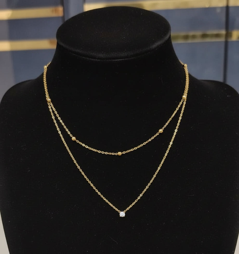 Double-layered gold necklace on a mannequin bust with price label '260'.