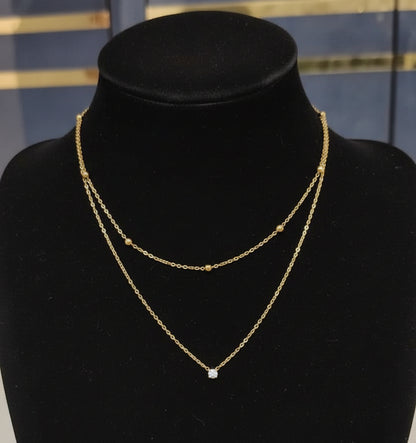 Double-layered gold necklace on a mannequin bust with price label '260'.